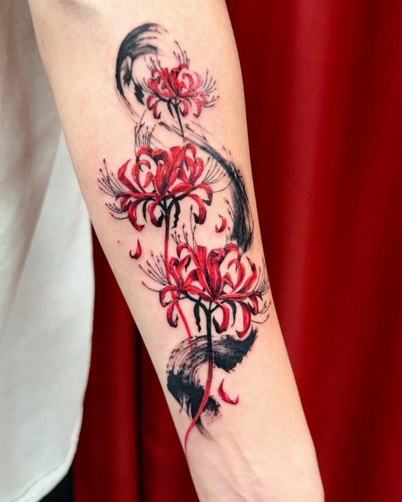 Red spider lily tattoo with black ink brushstrokes on a person's forearm.